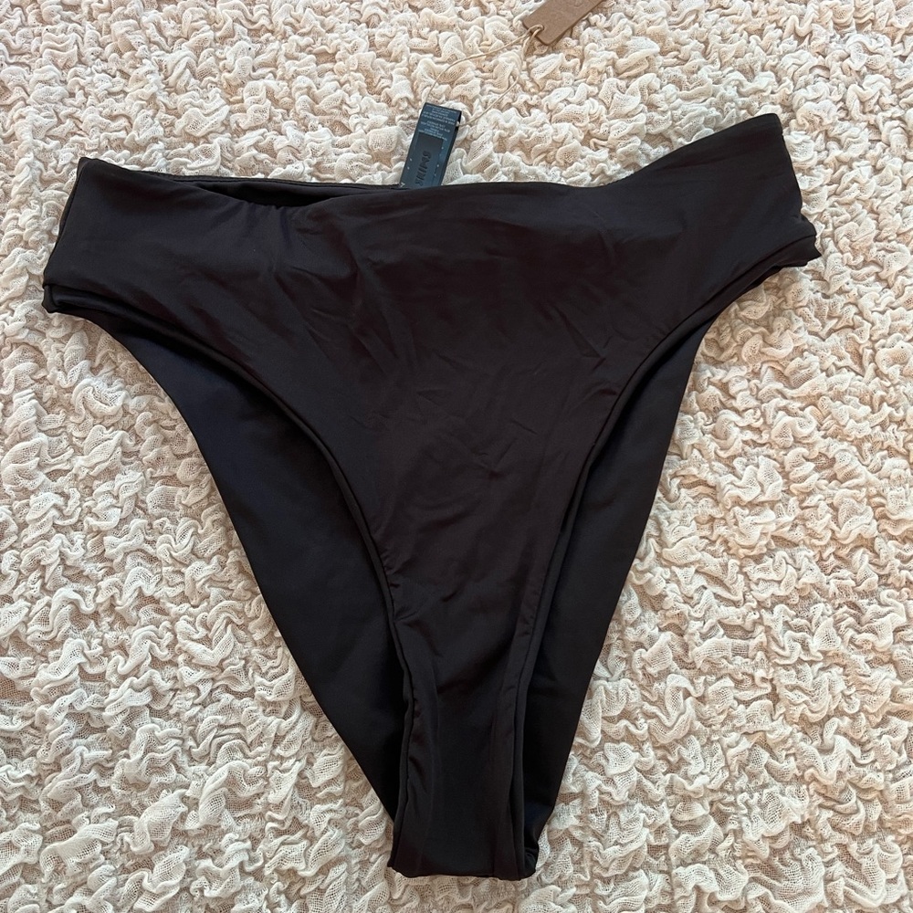 Black Skims mid waist swim bottom.